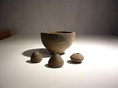 Topf und drei Spinnwirtel aus grauem Ton